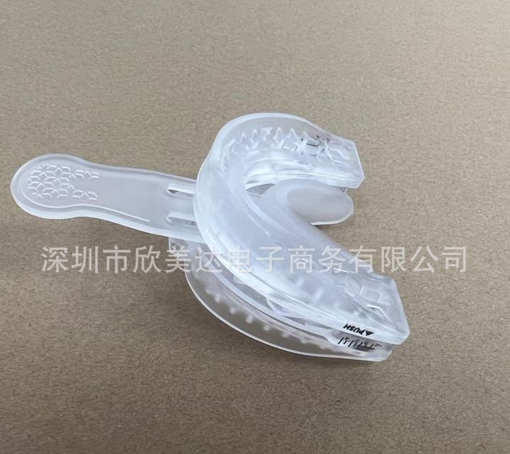 Clear adjustable mouthpiece beside its fitting tool.