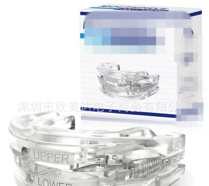 Clear adjustable mouthpiece with the graduated scale, retail box behind.