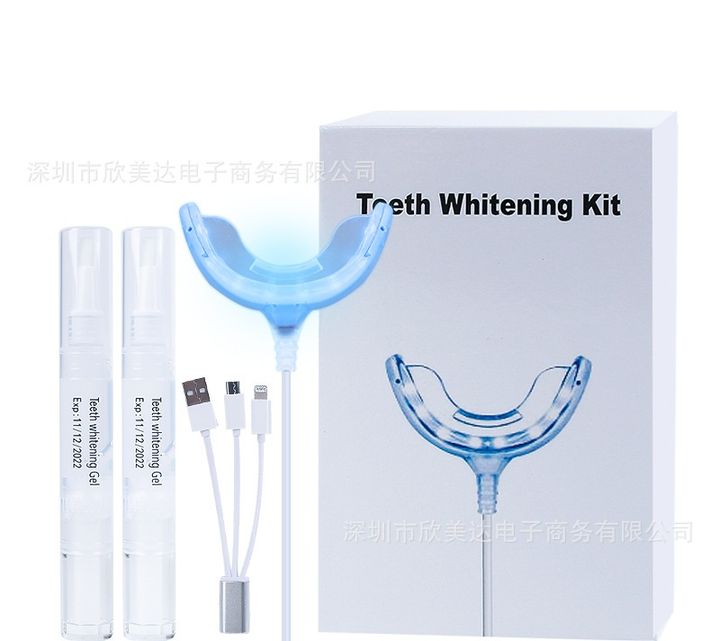 Phone-powered whitening kit with its box, LED tray, cable and pens.