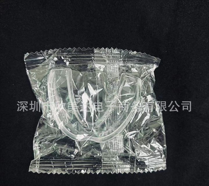 Clear boil-and-bite night guard sealed in its pouch, second size.