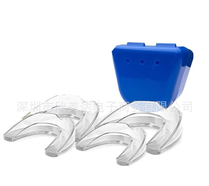 Four clear night guards beside a blue vented storage case.