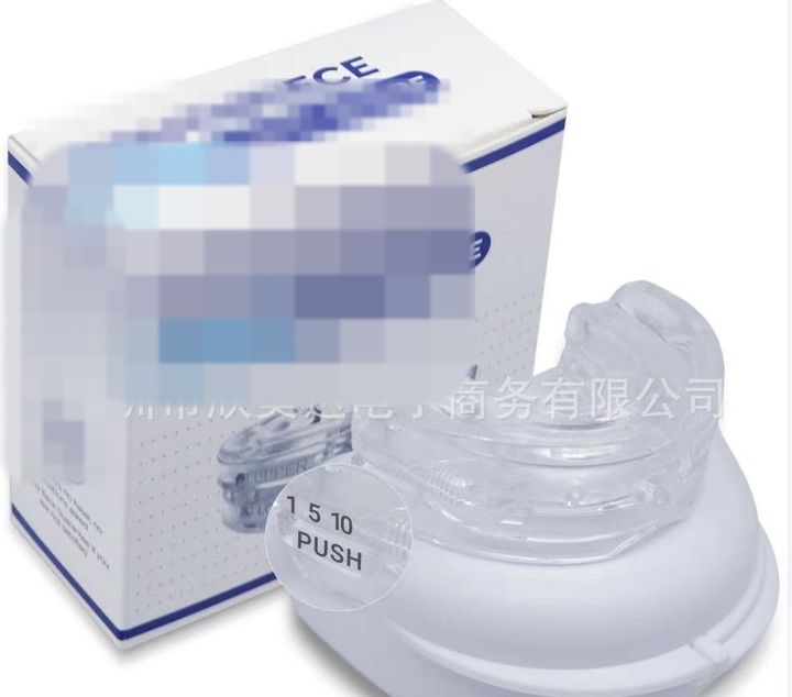 Clear adjustable mouthpiece on its case with a magnifier over the scale, box beside.