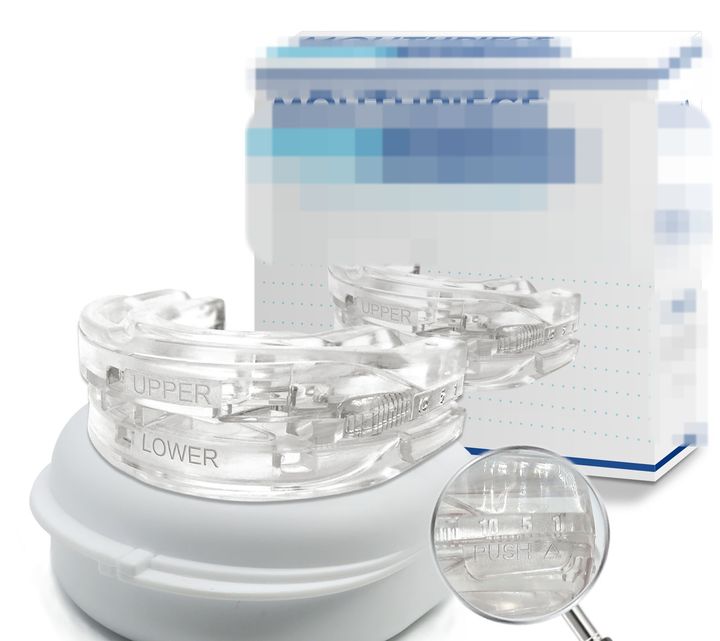 Clear adjustable mouthpiece on its white case, retail box behind.