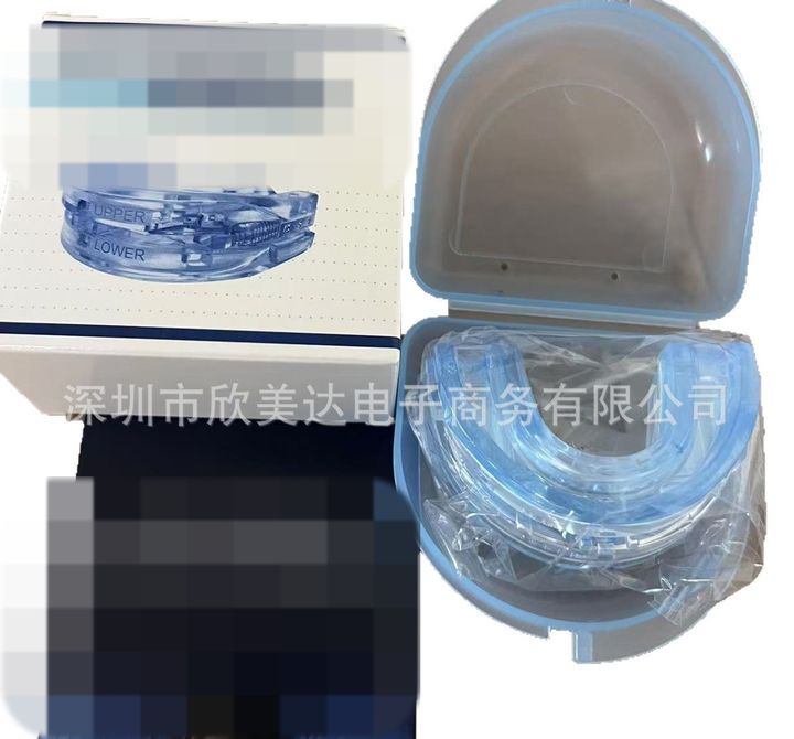 Blue night guard in its clear hinged case with a small retail box and card.