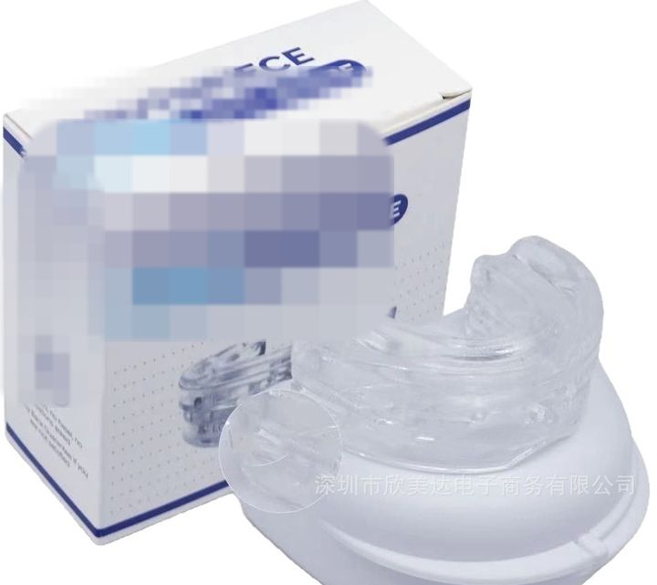Clear adjustable mouthpiece resting on its white case beside the retail box.