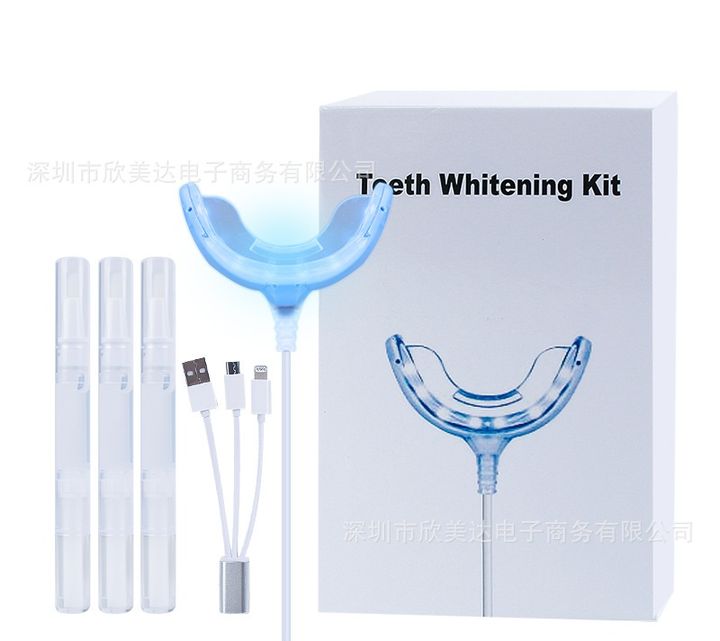 Whitening kit with its box, LED tray, three-way cable and pens.