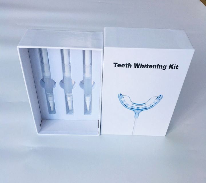 Whitening kit box opened to show the pens and the tray in their insert.