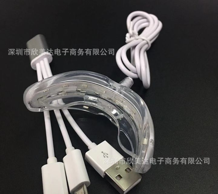16-LED whitening tray light with its three-way adapter cable.