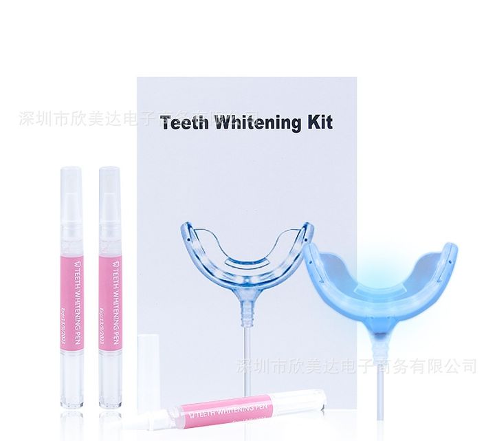 Whitening kit with its box, LED tray and three pink pens.