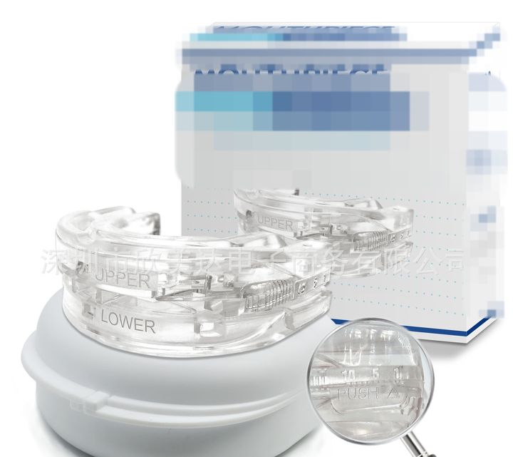Clear adjustable mouthpiece on its white case, retail box behind.