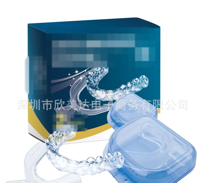 Two clear night guards with a blue storage case, the retail box behind.